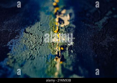 A blurred background featuring layers of green, blue, and yellow paint, creating a vibrant abstract effect. Stock Photo