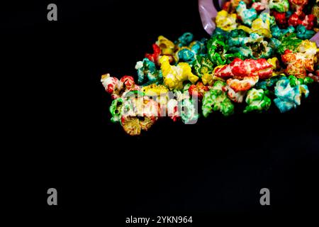 Close up of colorful popcorn scattered on a black background, cinema and popcorn concept Stock Photo