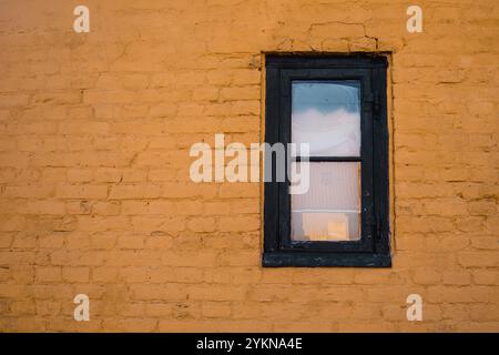 Old window with copy space of yellow brick wall Stock Photo