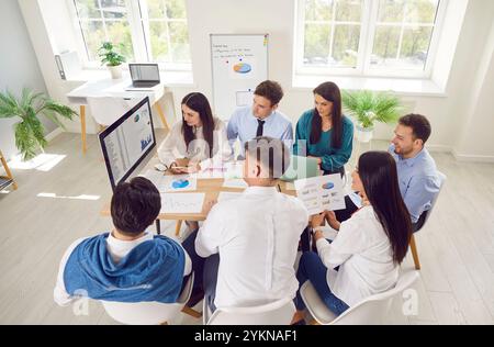 Team Of Colleagues Working On Business Accounting With Computer Stock Photo