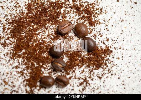 Ground Coffee and Whole Roasted Coffee Beans Displayed Together in a Rich Aromatic Composition Stock Photo