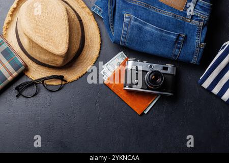 A travel items and clothes arranged on a dark background, flat lay style, with copy space for your product Stock Photo