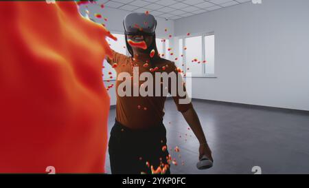 Asian young woman in virtual reality headset paints with wireless controllers, uses gestures to create abstract online artwork. Holographic 3D animation of paint drops. Augmented reality technology. Stock Photo