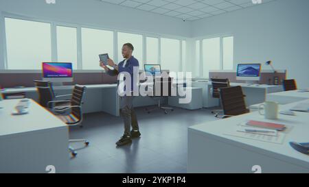 Creative African American designer uses digital tablet computer and AI interior design software to decorate office room. 3D graphics of holographic furniture and equipment. Futuristic VFX animation. Stock Photo