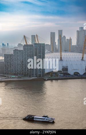 Aerial view  of Uber Boat Thames Clippers river ferry and the O2 Arena entertainment venue, Greenwich Peninsula, East London, Stock Photo