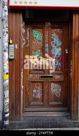 Graffiti in a door way along Brick Lane, London, showing the creativity and cultural diversity of the road. Stock Photo