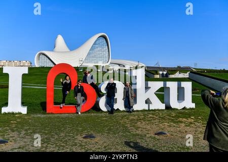 Baku, Azerbaijan. 15th Nov, 2024. People pose for photos outside the Heydar Aliyev Center in Baku, capital of Azerbaijan, Nov. 15, 2024. Credit: Cao Yang/Xinhua/Alamy Live News Stock Photo