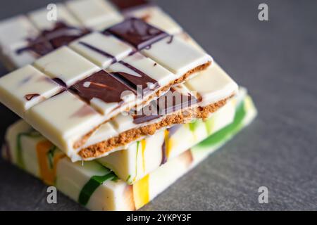 Piece of trend Dubai white chocolate with halva paste. Confectionery handmade sweets at home in the kitchen.  Stock Photo