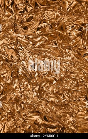 Fullframe crumpled copper foil shining texture background. Stock Photo