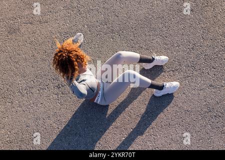 woman in sportswear doing abdominal exercises Stock Photo