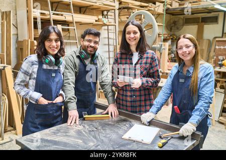 A group of diverse workers, both young and older, working together in a lumberyard. They demonstrate teamwork, collaboration, and skills development i Stock Photo