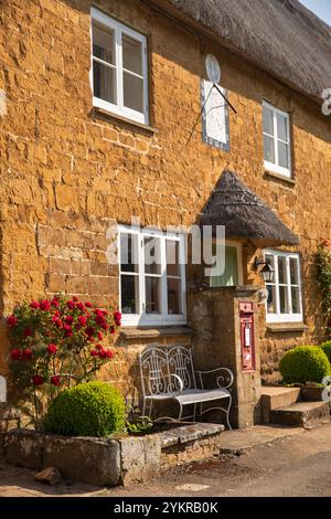 UK, England, Oxfordshire, Wroxton, Main Street, The Old Post Office traditional thatched house Stock Photo