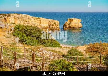 Beautiful Landscape of Sao Rafael's Beach with boardwalk and sky in the background, in Albufeira, Portugal Stock Photo