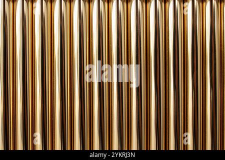 Golden pipes vertical stacked , abstract lines textured backdrop, close up Stock Photo