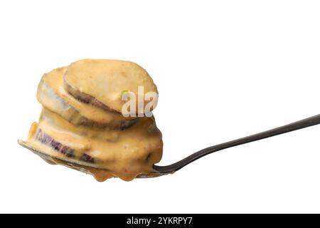 spoon full of sliced eggplant mixed with batter for frying isolated white background, cooking steps of crispy and flavorful dish, selective focus Stock Photo