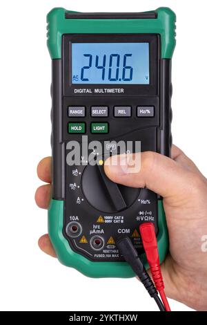 Hand Holding Green Digital Multimeter Displaying Voltage Stock Photo