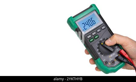 Hand Holding Green Digital Multimeter in Action Stock Photo