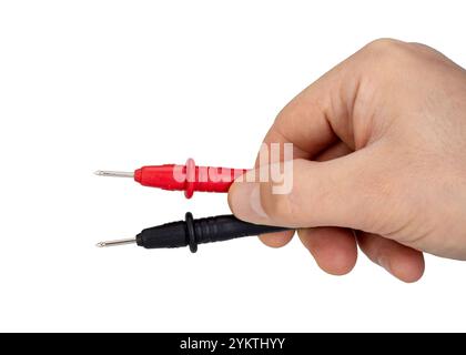 Hand Holding Red and Black Testing Probes Close Up Stock Photo