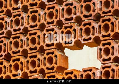 Abstract Pattern of Orange Clay Bricks with Circle Cutouts Stock Photo