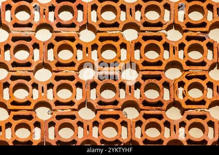 Abstract Pattern of Orange Clay Bricks with Circle Cutouts Stock Photo