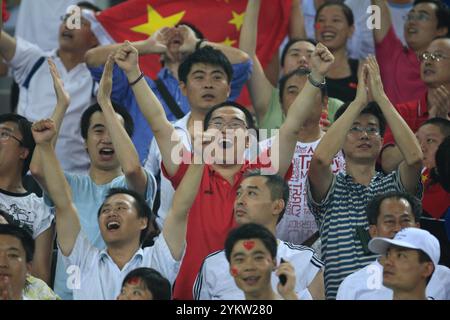 TIANJIN, CHINA - AUGUST 6:  Chinese fans celebrate a goal during a Group E soccer match between China and Sweden at the Beijing Olympic Games women's soccer tournament August 6, 2008 in Tianjin, China. Editorial use only. (Photograph by Jonathan Paul Larsen / Diadem Images) Stock Photo