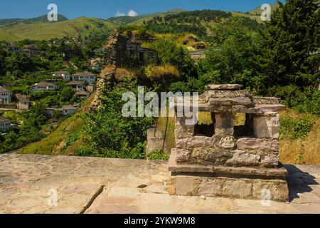 View over the UNESCO World Heritage Site Gjirokaster and Drino Valley, Albania. Seen from castle roof. Mediterranean-style stone chimney in foreground Stock Photo