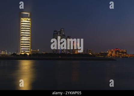 A picture of the Etihad Towers, the Abu Dhabi National Oil Company Headquarters and the Emirates Palace Mandarin Oriental Hotel at night Stock Photo