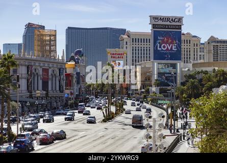 A picture of the Las Vegas Boulevard South with traffic, palm trees and casinos on both sides of it Stock Photo