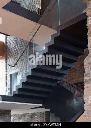 Stairs linking new and historic floor levels. Hay Castle, Hay-on-Wye, United Kingdom. Architect: MICA, 2022. Stock Photo