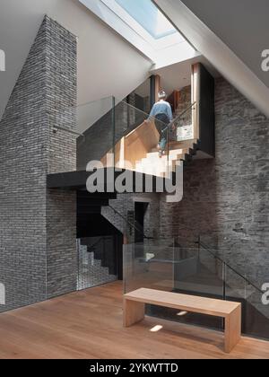 Roof light, stairway and reclaimed brick and salvaged stone walls. Hay Castle, Hay-on-Wye, United Kingdom. Architect: MICA, 2022. Stock Photo