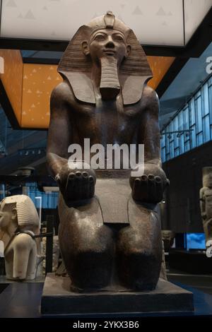 Large granite statue of a kneeling Queen Hatshesput offering 'nu' pots displayed in the recently-opened Grand Egyptian Museum (GEM) in Cairo, Egypt. Stock Photo