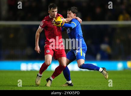 Accrington Stanley's Donald Love (left) and AFC Wimbledon's James Furlong battle for the ball during the Sky Bet League Two match at Cherry Red Records Stadium, London. Picture date: Tuesday November 19, 2024. Stock Photo