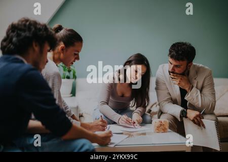 High school students collaborate on a project with their professor at home Stock Photo