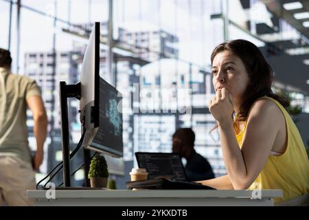 Data scientist developing and maintaining deep learning APIs solving complex problems. IT professional in office training predictive models capable of handling language processing tasks Stock Photo