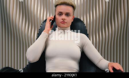 Caucasian woman gamer user programmer hacker girl female businesswoman sit in black chair futuristic studio cyber security modern innovation call Stock Photo