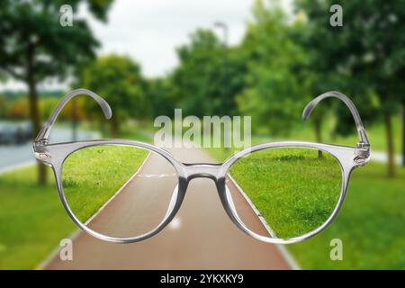 View on city park with bicycle lane through eyeglasses Stock Photo