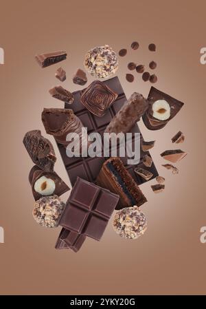 Different chocolate products in air on brown background Stock Photo
