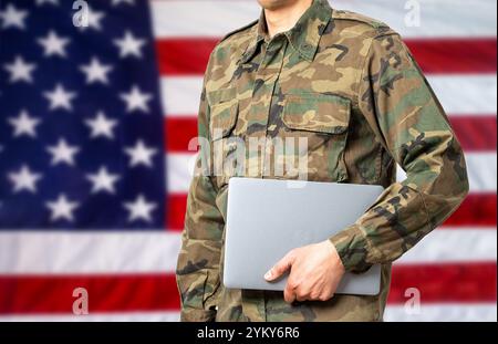 Cropped shot of a soldier computer programmer with USA flag in the background and copy space Stock Photo