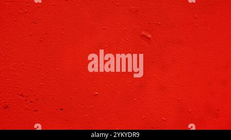 Abstract red background texture of handmade concrete or plaster wall.. Metal plate with old paint. Stock Photo