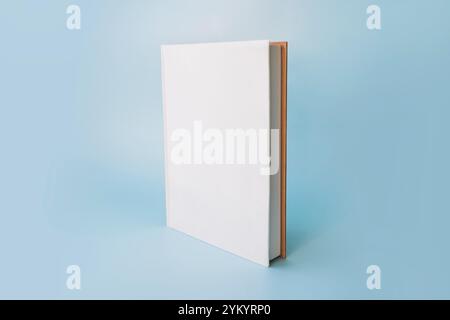 Book flat front cover white standing vertical on blue background Stock Photo