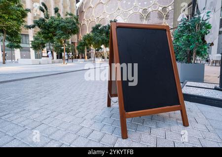 Chalkboard stand in wooden frame for menu restaurant or cafe welcome easel with copy space. street sidewalk Stock Photo