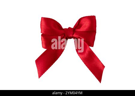 Red satin silk ribbon tied bow isolated on white. Beautiful gift wrapping decorative detail. Trendy ornament. Stock Photo