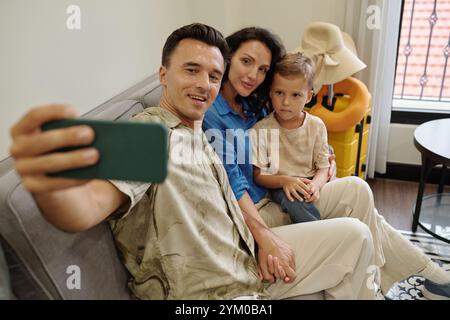 Taking Family Selfie on Comfortable Couch Stock Photo