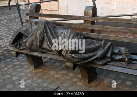 Rome, Italy - October 31, 2024: Homeless Jesus the bronze sculpture by Timothy Schmalz depicting Jesus as a homeless person, sleeping on a park bench Stock Photo