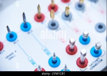 Dental implant surgery tools on a white surface. Close-up of golden drill bits and precision instruments in a medical or dental clinic setting. Stock Photo