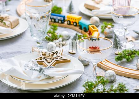 Traditional festive place setting for Christmas, decorated with wooden railways Stock Photo