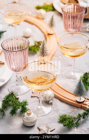 Traditional festive place setting for Christmas, glasses of sparkling wine Stock Photo