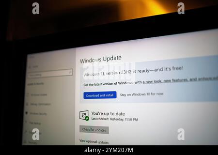 Paris, France - Sep 10, 2024: Windows Update screen on a laptop showing Windows 11 version 23H2 ready for installation, with the option to Download and install, highlighting upgrade availability. Stock Photo