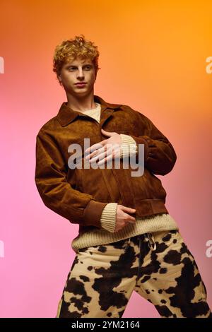 A young man showcases an eclectic holiday outfit, combining a cozy sweater and a fashionable suede jacket. Stock Photo