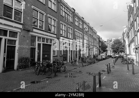 Amsterdam, NL - OCT 14, 2021: Street view and generic architecture in Amsterdam with typical Dutch style buildings. Amsterdam is one of Europe's most Stock Photo